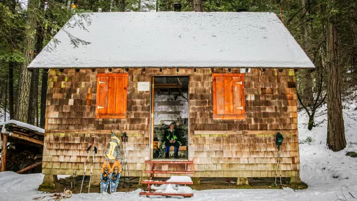 The rustic Liburn research cabin in snowy woods.