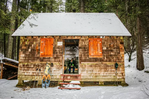 The rustic Liburn research cabin in snowy woods.